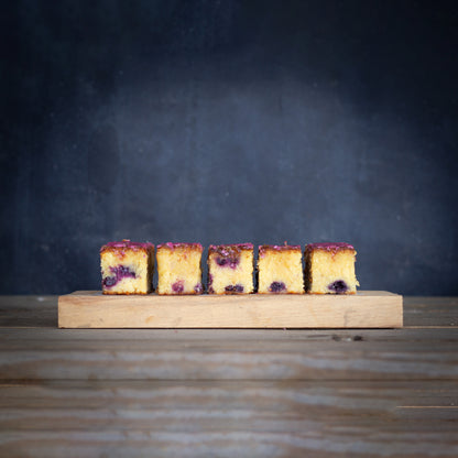 Six cake slices on a wooden board with a dark background